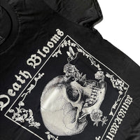Angled view of black unisex T-shirt featuring gothic floral border with hummingbird drinking from skull flower design. 'Death Blooms' and 'INHUMANUM' printed in white – INHUMANUM dark art streetwear
