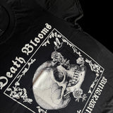 Angled view of black unisex T-shirt featuring gothic floral border with hummingbird drinking from skull flower design. 'Death Blooms' and 'INHUMANUM' printed in white – INHUMANUM dark art streetwear