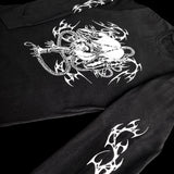 Side view of black long sleeve shirt with white manga-style rope-bound character and neo-tribal print