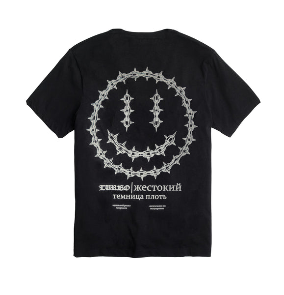 Back of INHUMANUM Dungeon Acid shirt – black short sleeve with chainlink smiley face and Russian text reading “The prison of flesh”